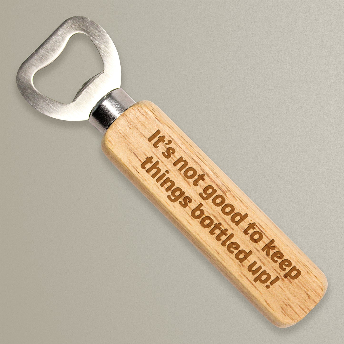 a wooden bottle opener with the phrase 'It's not good to keep things bottled up!' etched on the side.