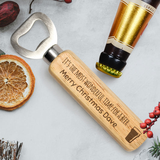 Wooden bottle opener with engraved text.
