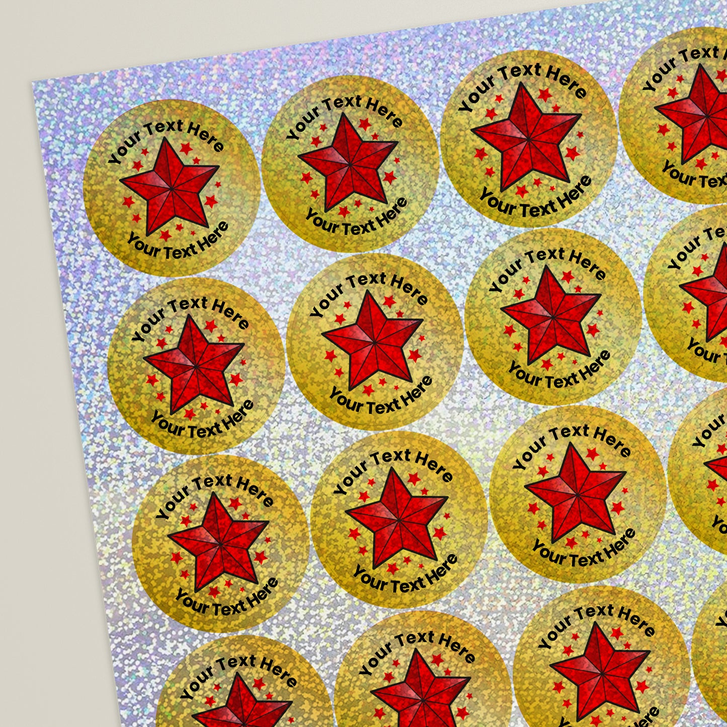 A sheet of gold holographic stickers with a central red star. The text 'Your Text Here' demonstrates the customisable text feature of the sticker.