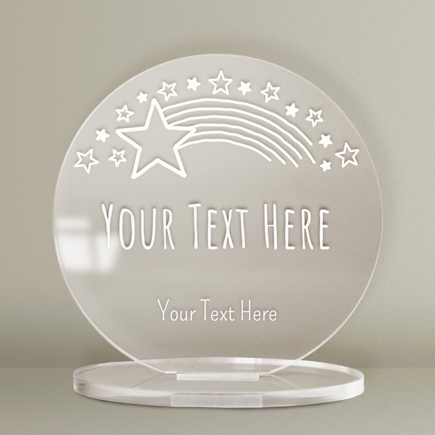 A clear circular acrylic plaque with a star design and custom text.