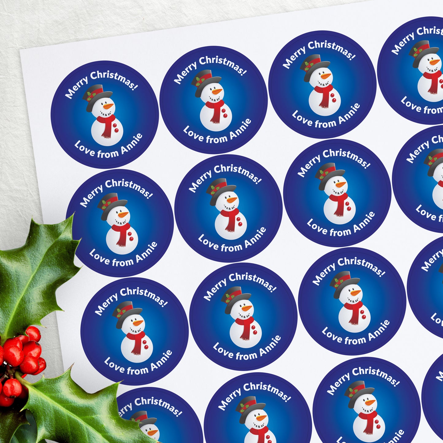 Blue stickers with a smiling snowman central with space above and below for personalisation.