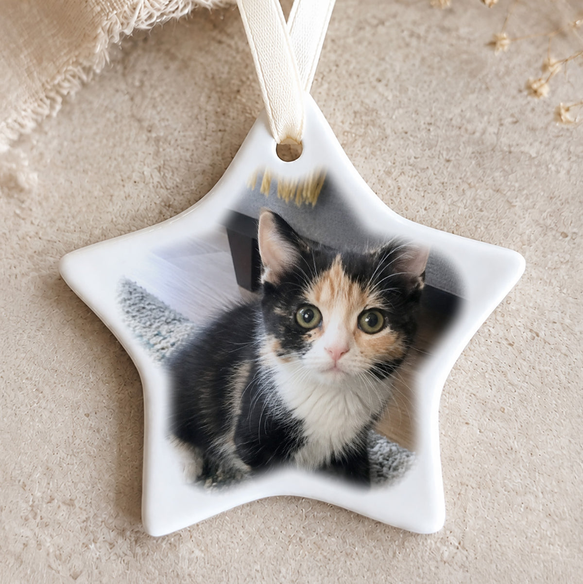 Personalised star-shaped ceramic Christmas bauble featuring an uploaded photograph