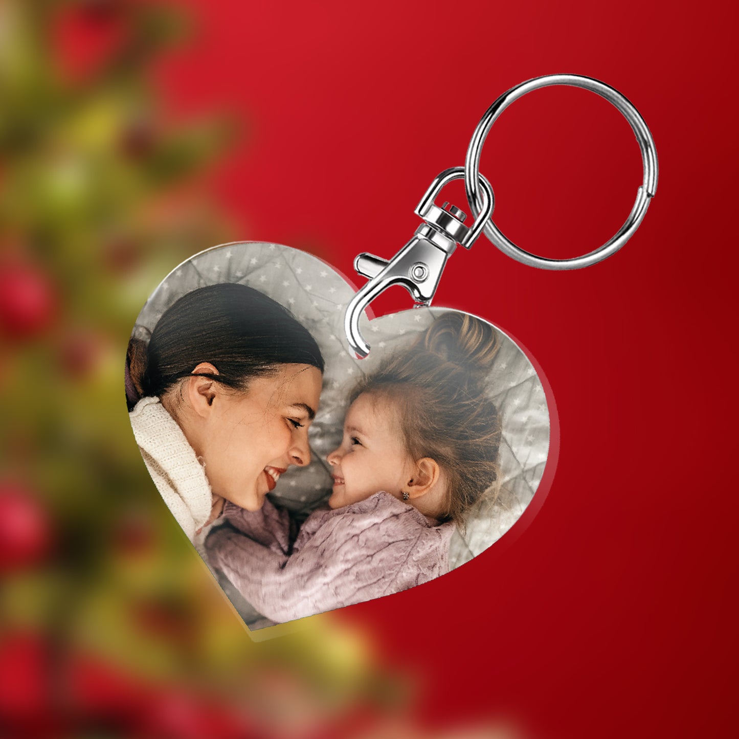 Heart-shaped keyring with a photo of a woman and a child.