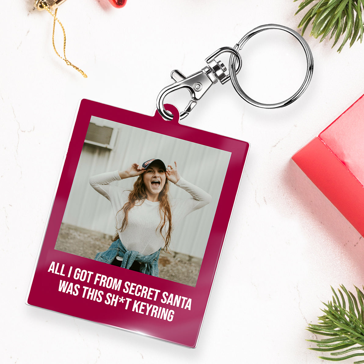 Keyring with a pink background featuring a photo of a person and humorous text.
