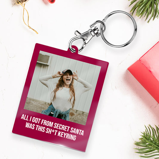Keyring with a pink background featuring a photo of a person and humorous text.