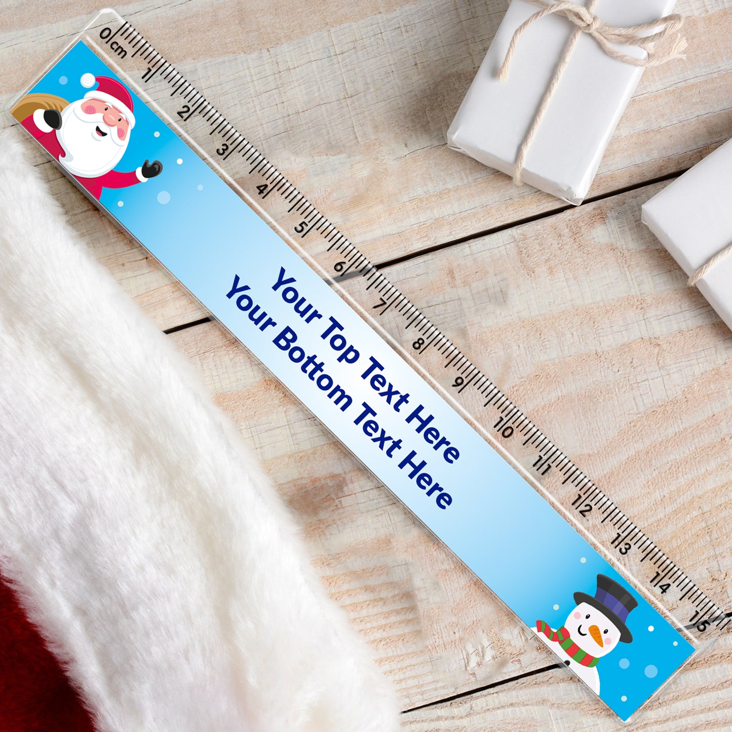 A personalised Christmas ruler with a Santa Claus and a snowman design, featuring a space for custom text.