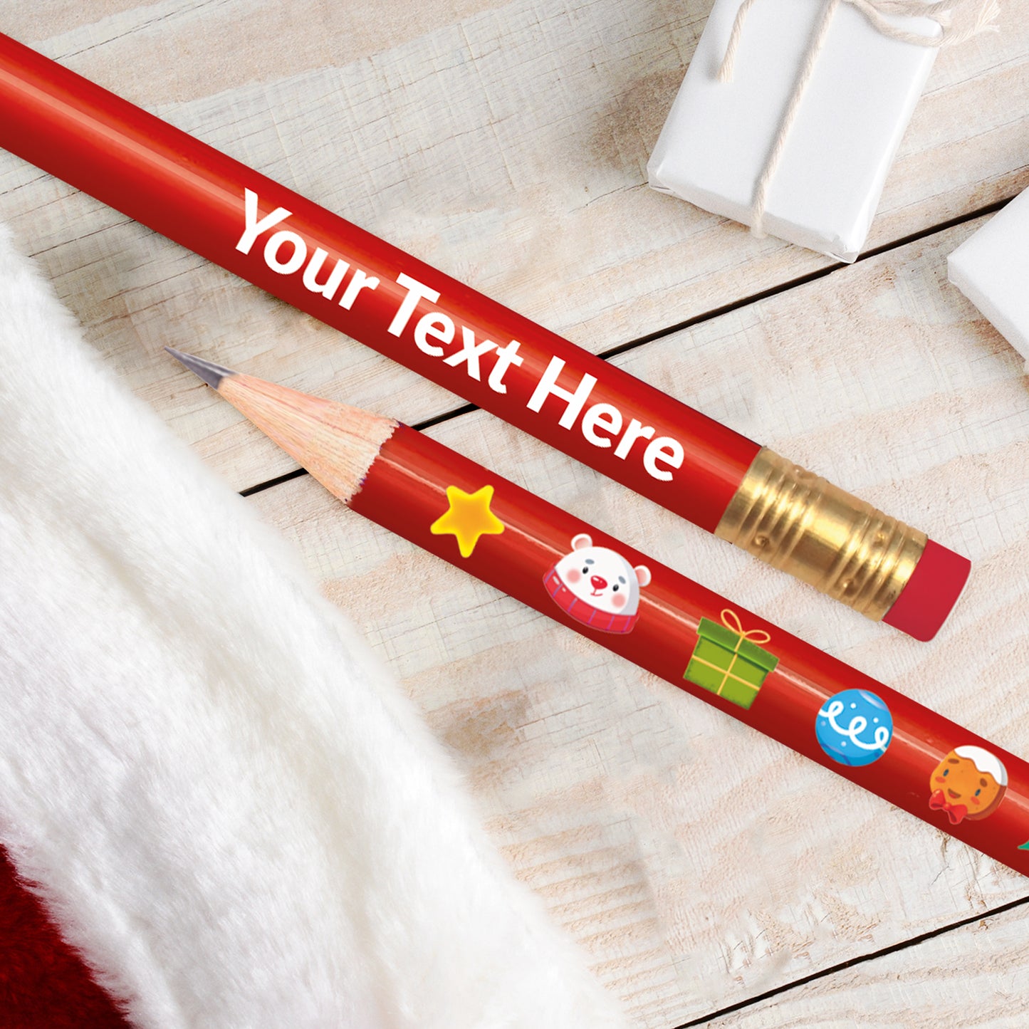 A red pencil with a Christmas theme, featuring decorations such as a reindeer, Santa Claus, and text space for a personalised message.