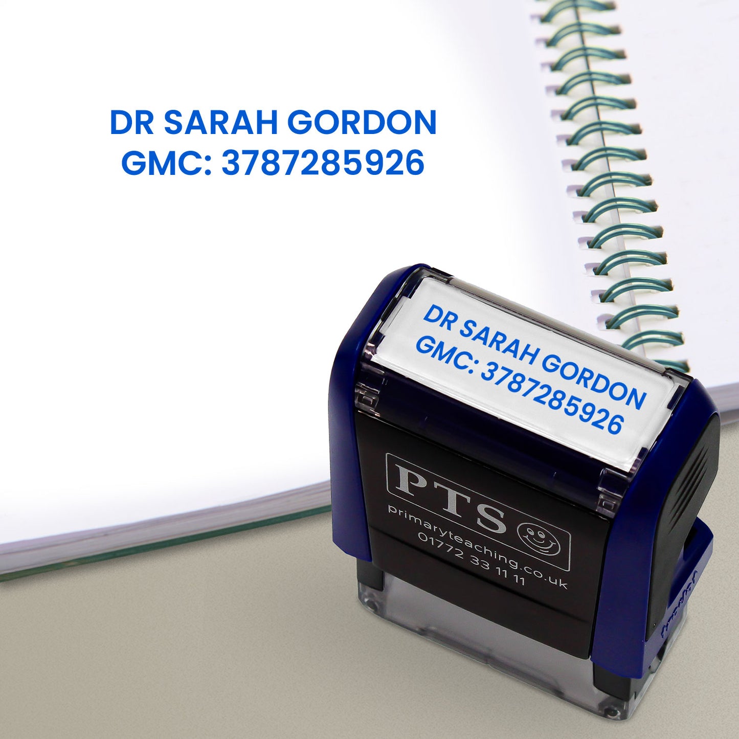 Rectangular self-inking stamper measuring 38mm by 14mm, featuring customisable text such as a healthcare professional's name and registration number; designed for medical documentation and administrative use. Stamps blue ink.