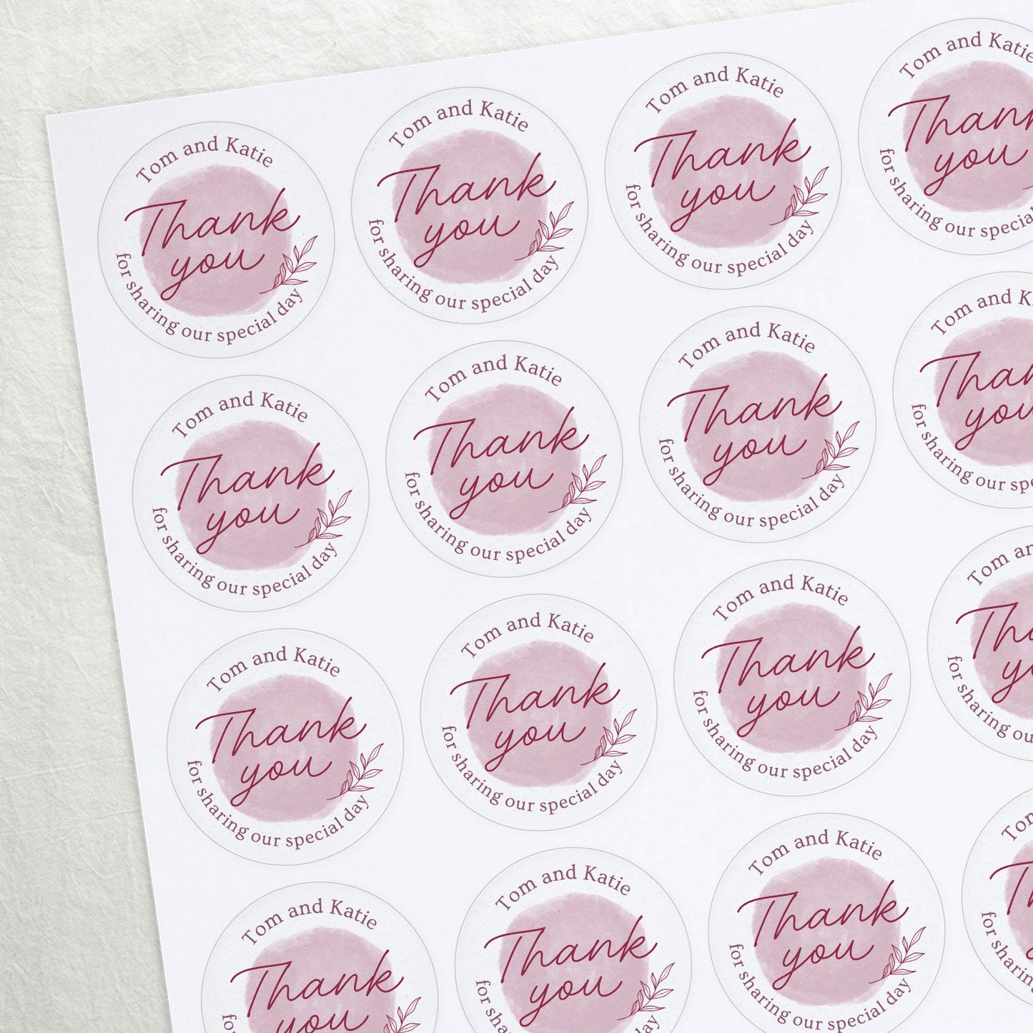 A personalised sticker with a watercolour swatch and the text 'Thank You' along with names and a date.