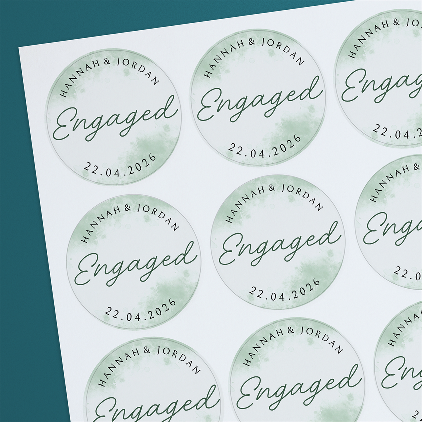 Round, white engagement sticker with sage watercolour hues and personalised text including names and a date.