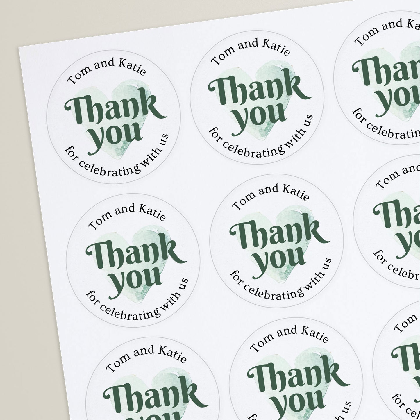 Round, white sticker with green text and a heart symbol, reading 'Thank You' and personalised with names.
