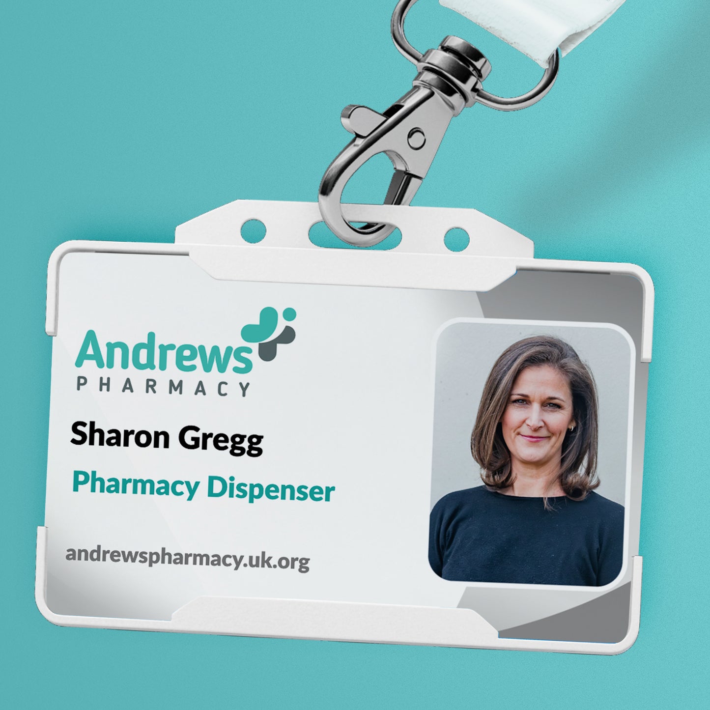 A personalised ID card in lanyard with a photo, logo, and text on it, held in a hand against a teal background.