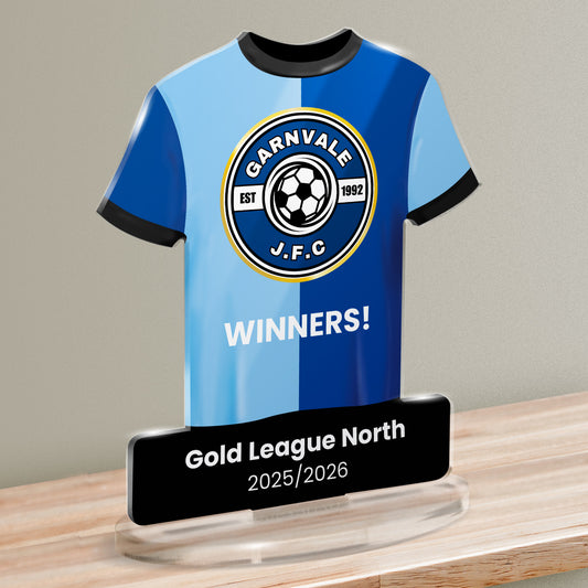 Acrylic t-shirt plaque showing light and dark blue halves sports shirt with a black trim featuring 'Garnvale J.F.C.' emblem and 'Gold League North' text below.