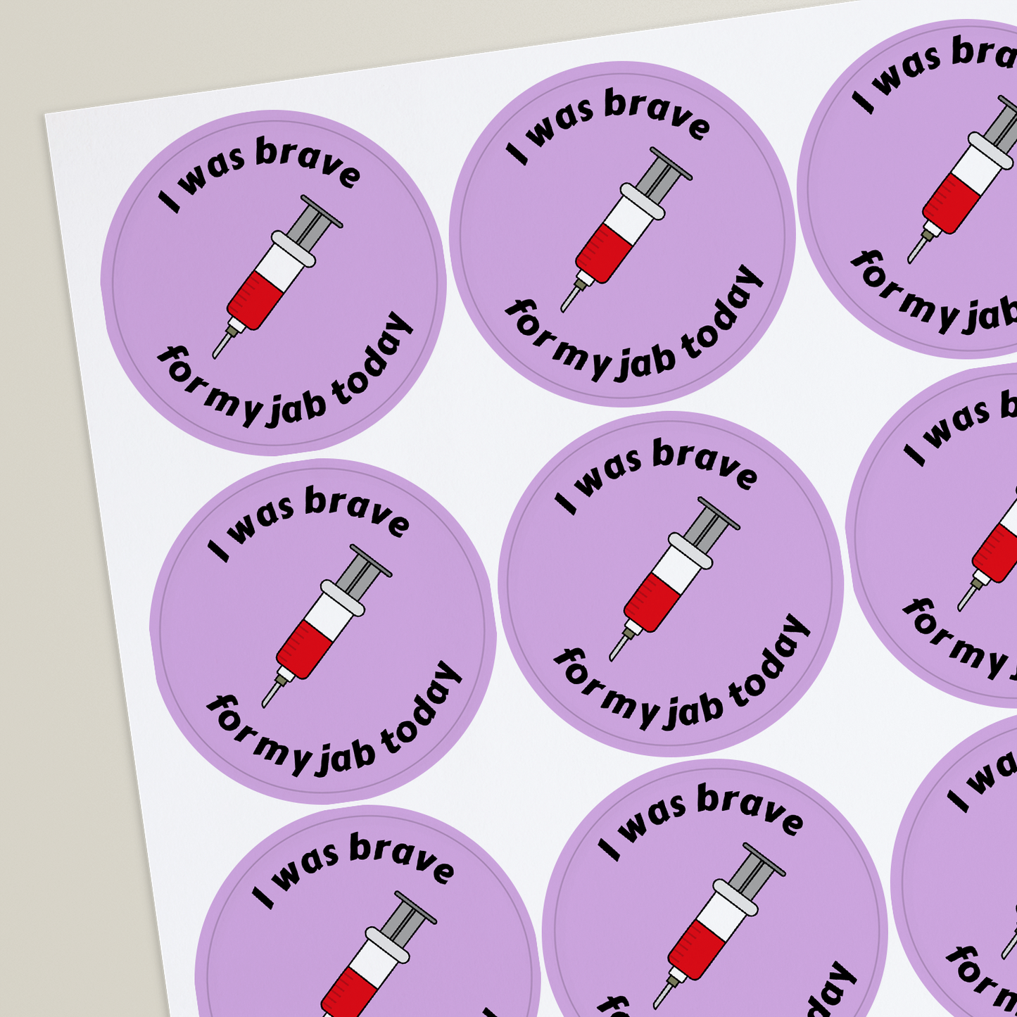 Round stickers with an illustration of a needle and personalised above and below