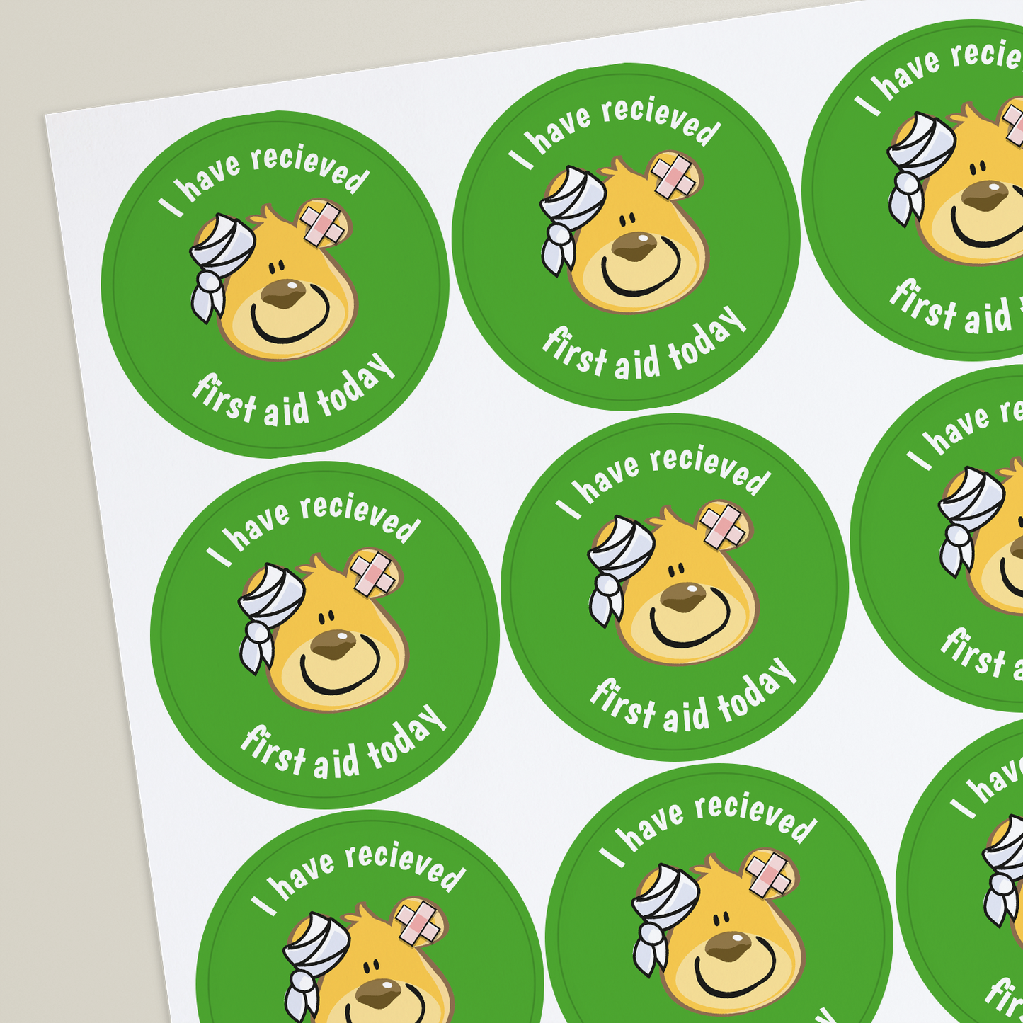 Round first aid sticker with a cartoon bear character, the text 'I have received my first aid today' and a bandage on its head.