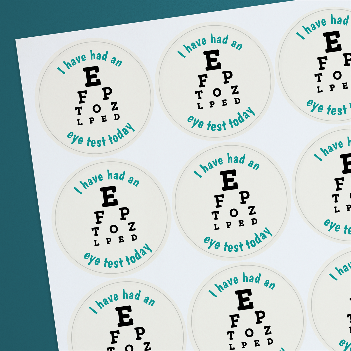 Round sticker with text and an eye chart design, indicating a personalised message for an eye test today.