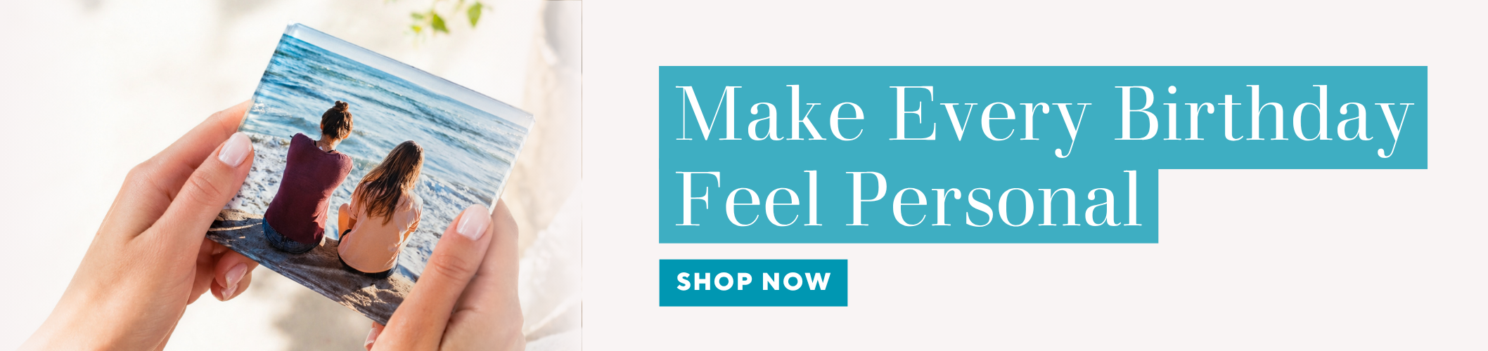 Person holding a card with a beach scene and promotional text 'Make Every Birthday Feel Personal' on a blue banner.