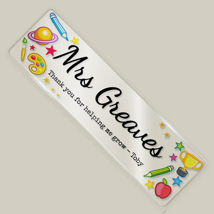 Personalised teacher acrylic bookmark with “Mrs Greaves” and thank you message, decorated with colourful school-themed illustrations.