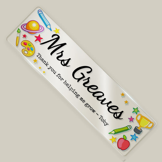 Personalised teacher acrylic bookmark with “Mrs Greaves” and thank you message, decorated with colourful school-themed illustrations.