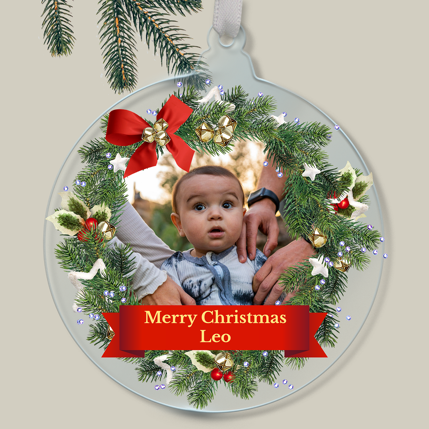 Personalised Christmas ornament with a child's photo within a wreath outline and 'Merry Christmas Leo' text.