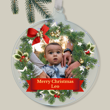 Personalised Christmas ornament with a child's photo within a wreath outline and 'Merry Christmas Leo' text.