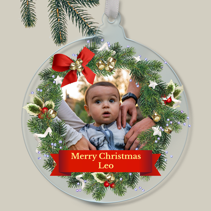 Personalised Christmas ornament with a child's photo within a wreath outline and 'Merry Christmas Leo' text.