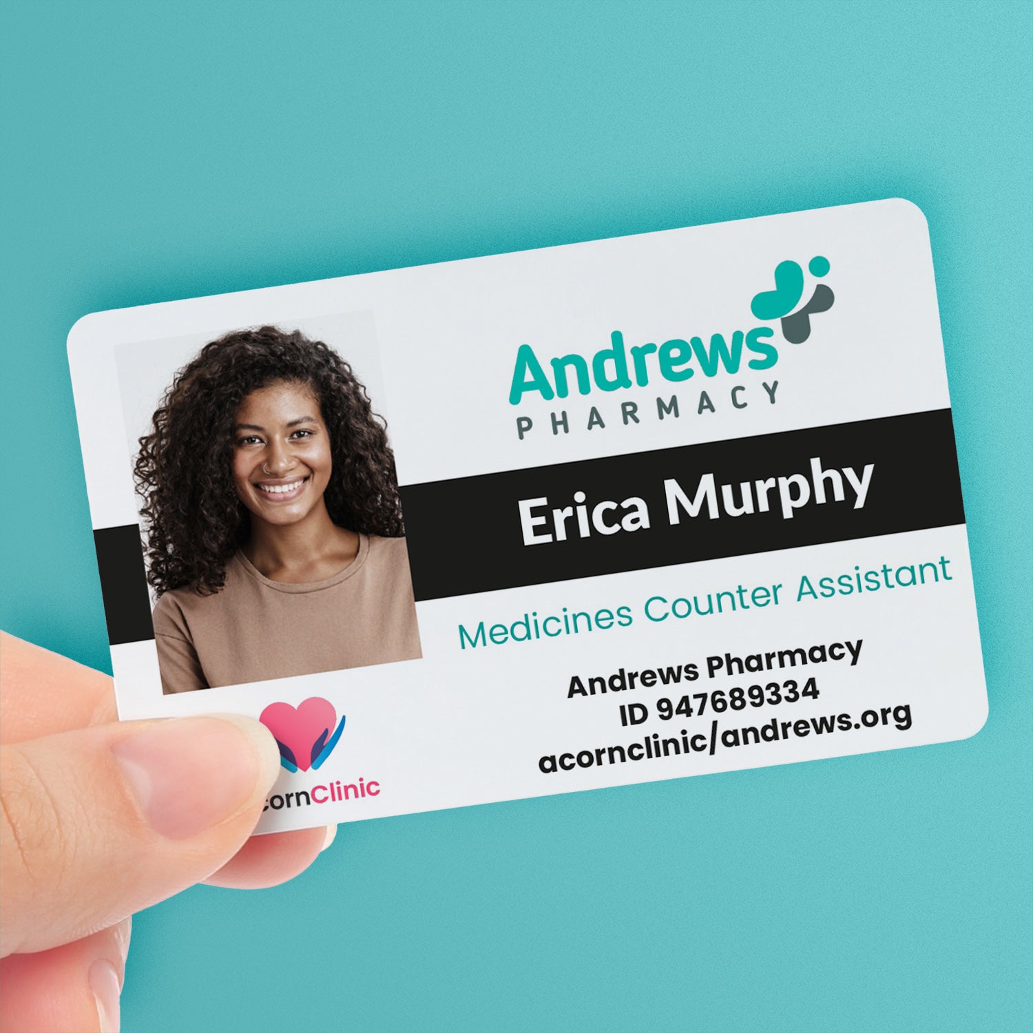 A personalised pharmaceutical ID card with a photo, company logo, clinic logo, and custom text. The ID card is held in a hand and has a black colour strip - with the name 'Erica Murphy' and the title 'Medicines Counter Assistant'.