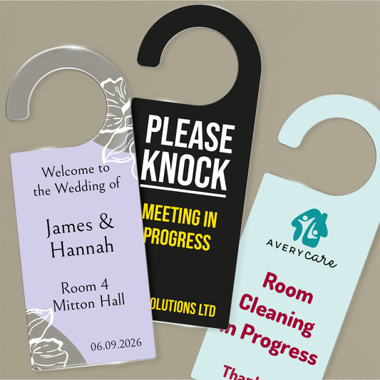 Three Acrylic Door Hangers left design ornate purple wedding design for 'James & Hannah', Middle design 'Please Knock Meeting In Progress on black background, right door hanger ' Room Cleaning in Progress' on a pale teal background