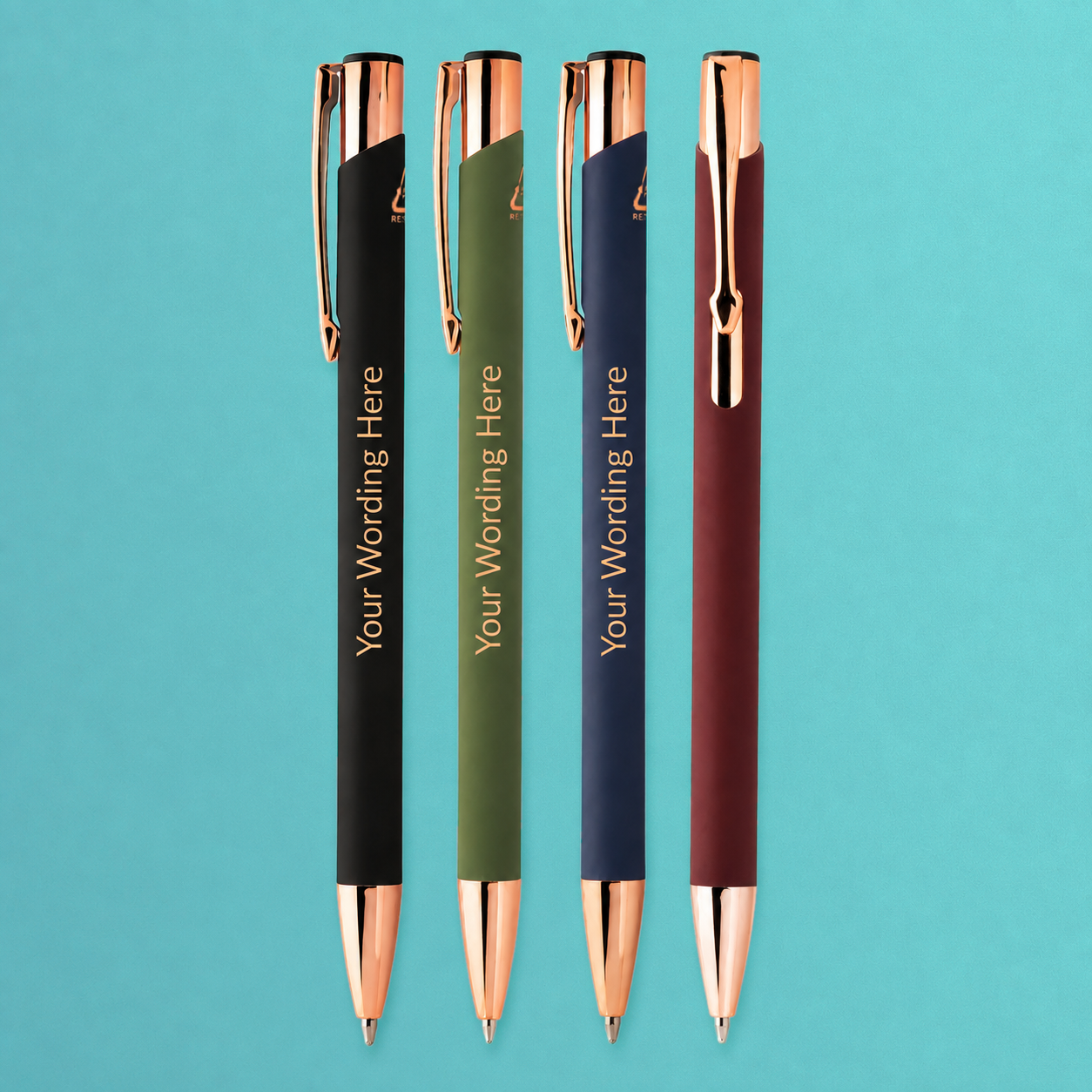 Personalised pens in black, green, navy and burgundy with rose gold trim, displayed upright on a teal background.