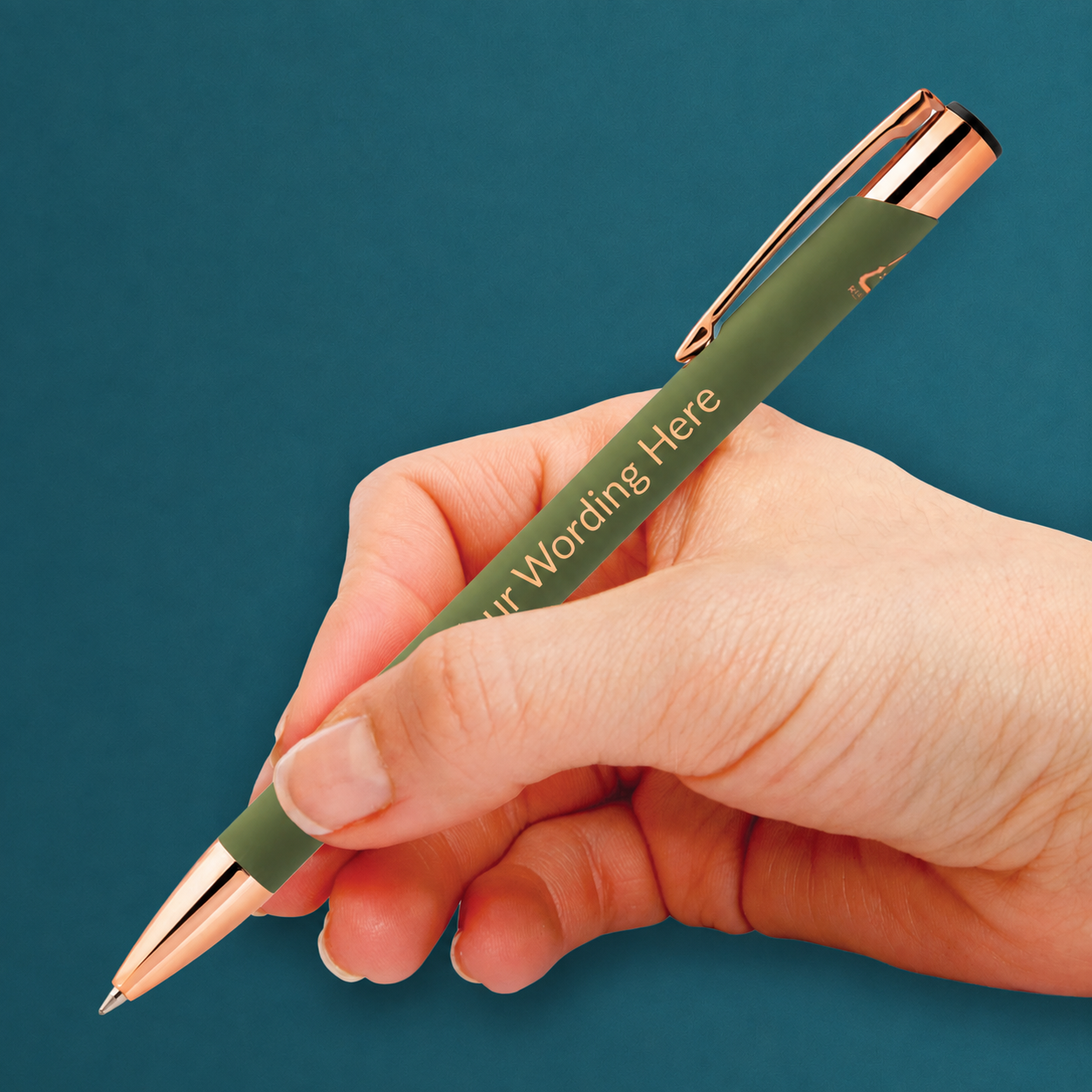Green personalised pen with rose gold detailing and engraved wording, shown being held in the hand.