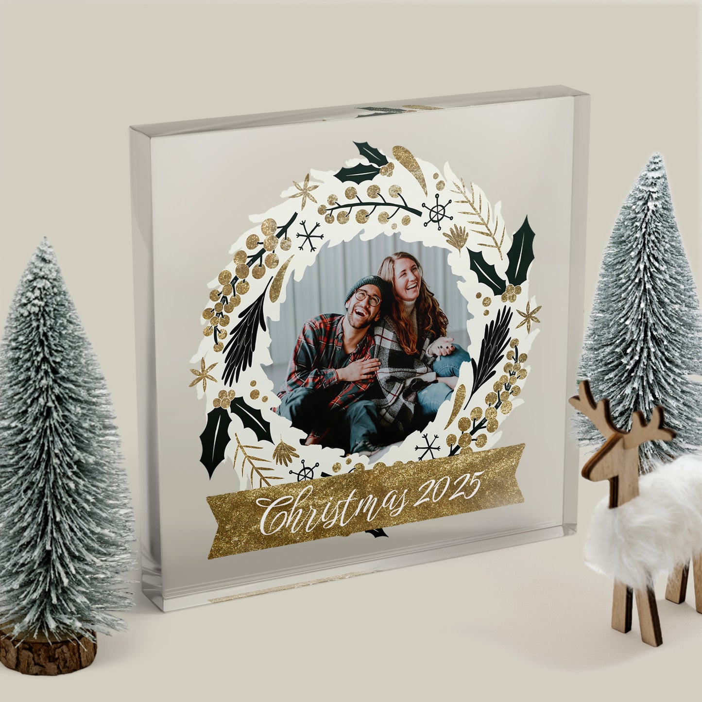 Decorative photo frame with Christmas design featuring a couple and 'Christmas 2025' text, surrounded by festive decorations.