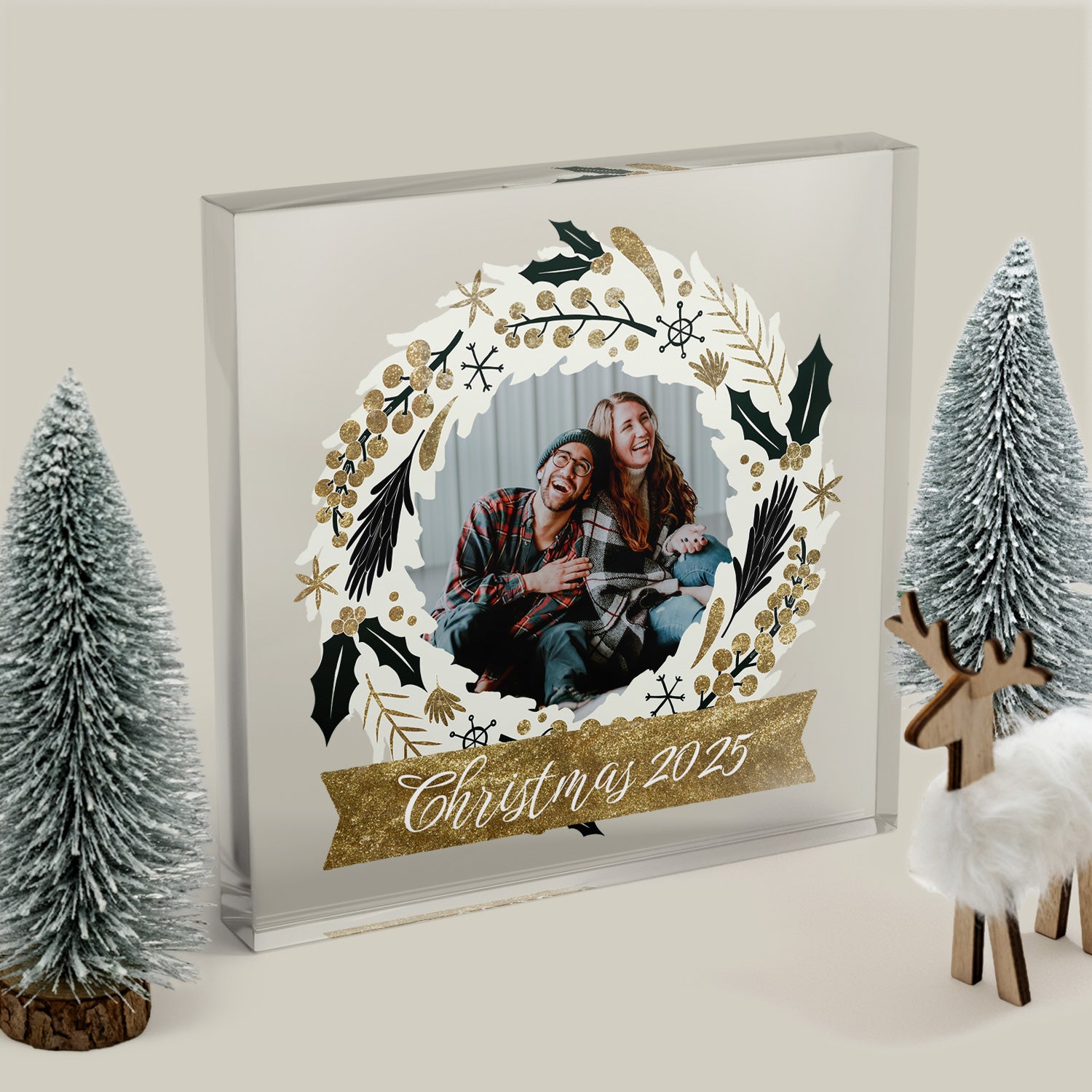 Decorative photo frame with Christmas design featuring a couple and 'Christmas 2025' text, surrounded by festive decorations.