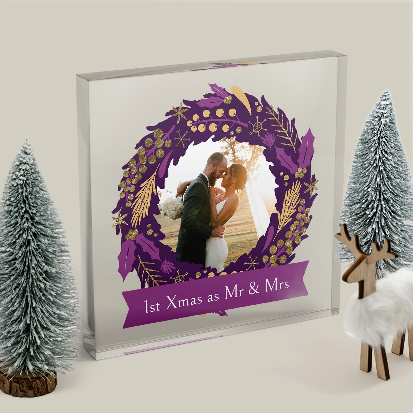 Decorative photo frame with a purple wreath design, showing a couple and text '1st Xmas as Mr & Mrs', surrounded by festive decorations.