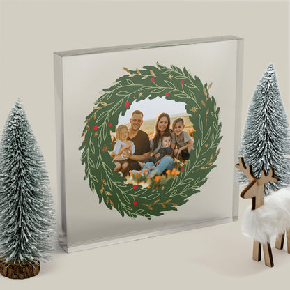 Framed family photo with a Christmas wreath design, surrounded by decorative trees and a deer.