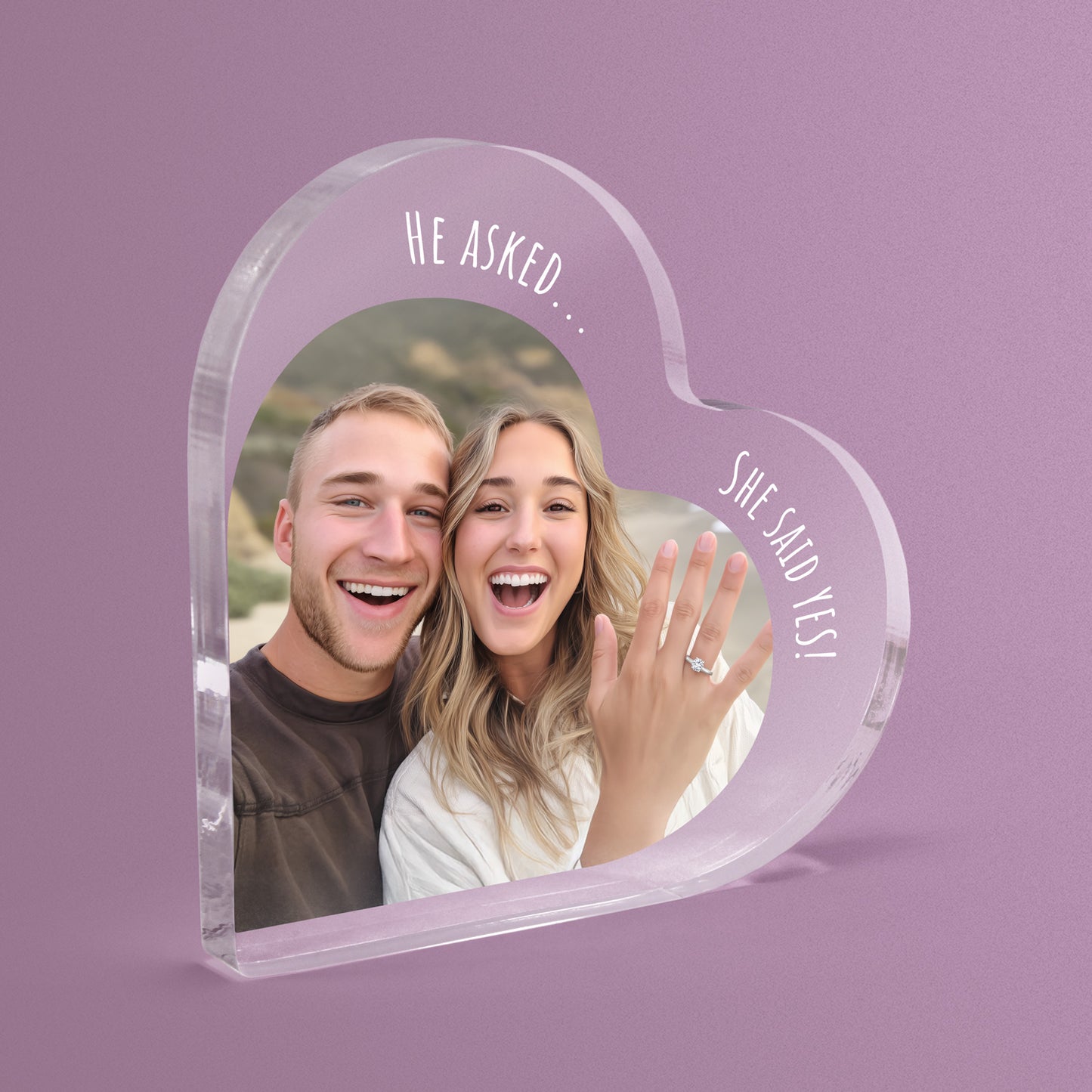 Heart-shaped acrylic photo block with a couple's picture and 'He Asked... She Said Yes!' text on a pink background.
