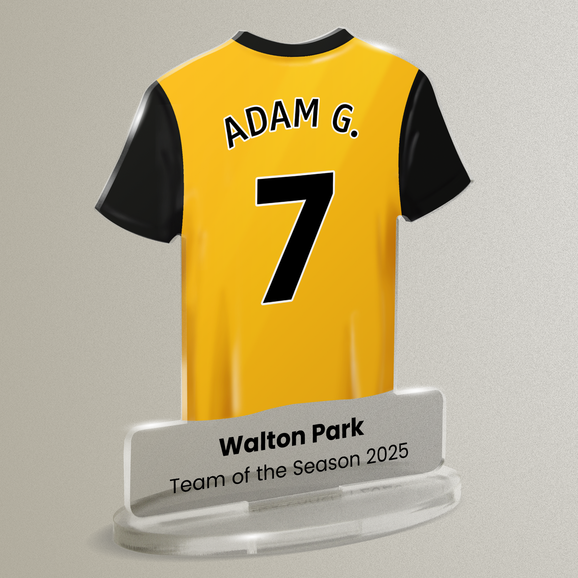 Acrylic t-shirt plaque with a yellow sports shirt design with black accents. Shirt has the wording 'Adam G' and number '7', with wording 'Walton Park' 'Team of the Season' underneath. Plaque is shown on a pale gray background.
