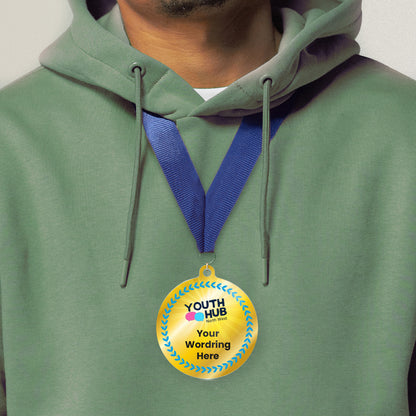 Acrylic personalised medal with blue ribbon showing blue design with blue wreath, Youth Hub logo and personalised wording. Worn around a persons neck wearing a green hoodie.