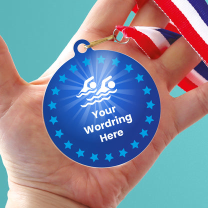 Acrylic personalised medal with stripy ribbon, in a hand, showing blue design with blue stars, swimming icon and personalised wording.