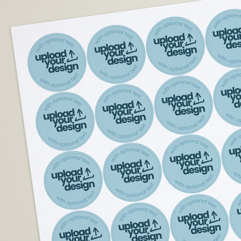 A sheet of round blue stickers with the text 'UPLOAD YOUR DESIGN' and an arrow indicating the area for custom text.
