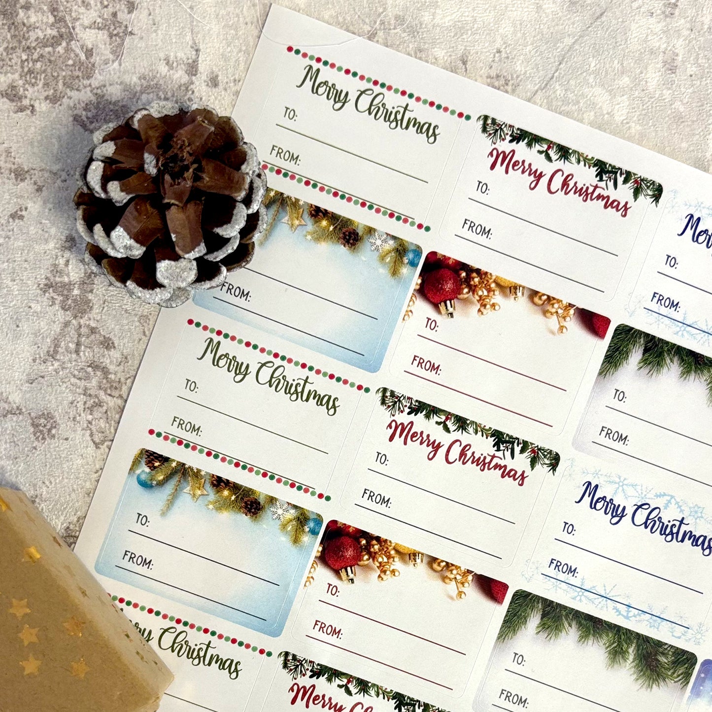 Sheet of Christmas gift tags with decorative elements on a textured surface.