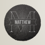 Round slate coaster with engraved name 'Matthew' on a light grey background