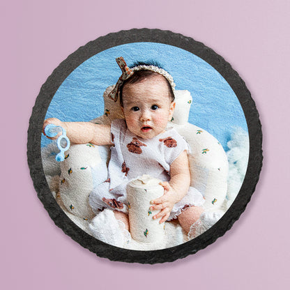 Photo of baby digitally printed onto natural circle slate coaster on a lilac background.