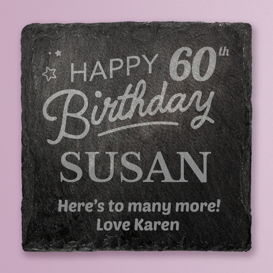 Slate coaster with engraved birthday message on a pink background
