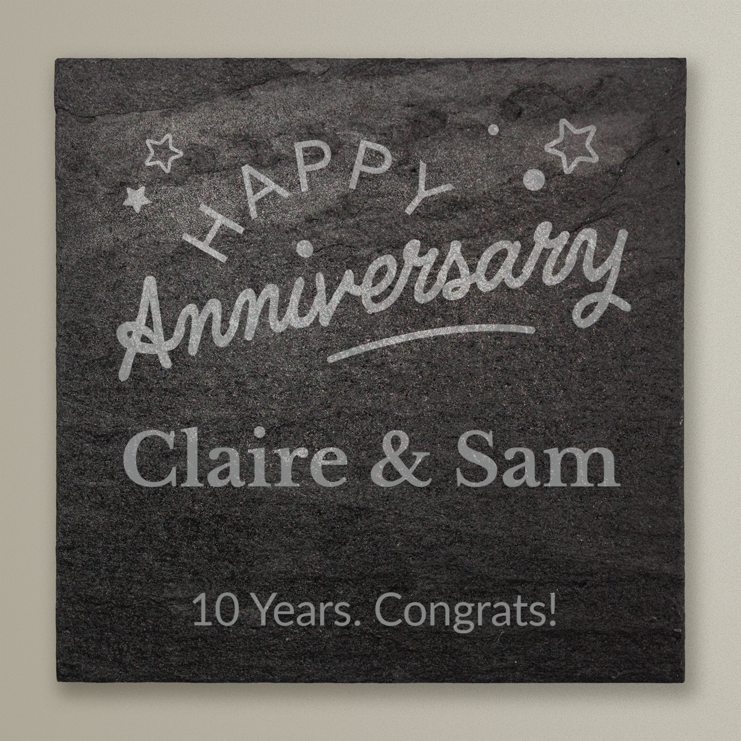 Slate tile with 'Happy Anniversary Claire & Sam 10 Years. Congrats!' text on a beige background