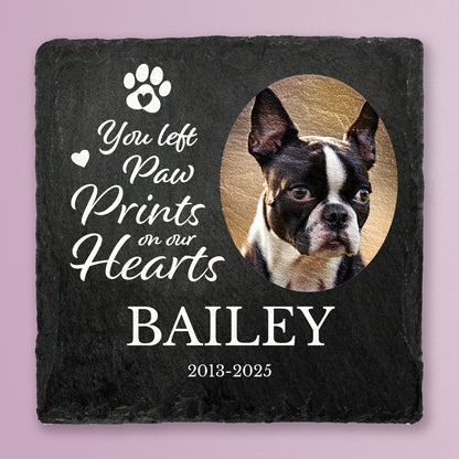 Slate coaster with printed photo of a dog with message You left paw prints on our hearts, Bailey, 2013-2025 in white text