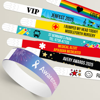Collection of colourful wristbands with various designs and text on a neutral background.  Each with customised colour and text.