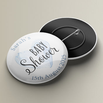 A personalised round badge with a pin backing, featuring text for a baby shower event.