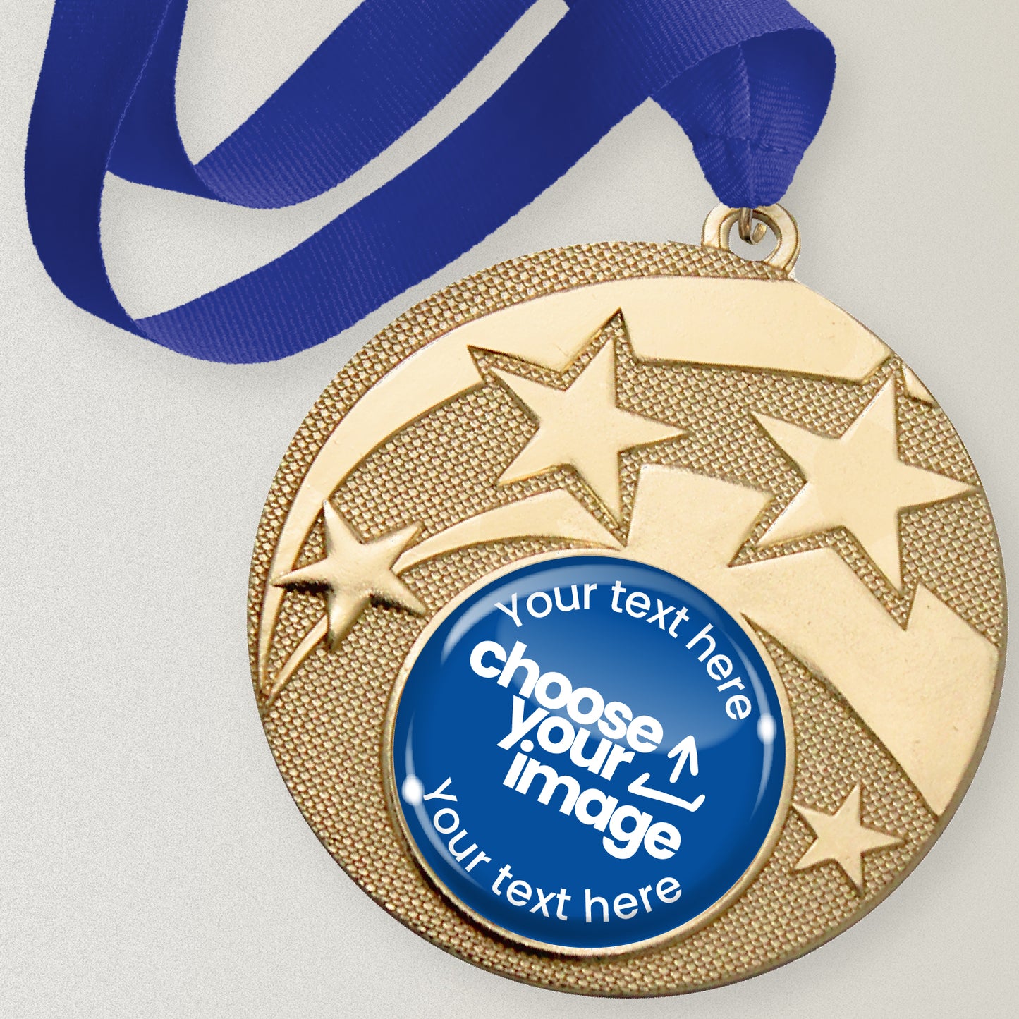 Gold medal with star design and customizable text and image area, attached to a blue ribbon.