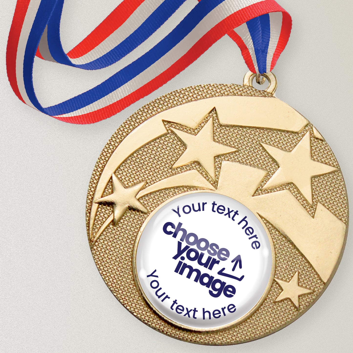Gold medal with star design and customizable text and image area, attached to a red, white and blue ribbon.