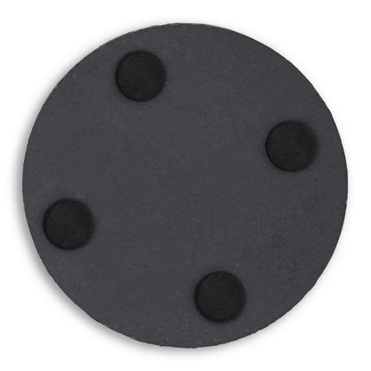 Under side of a circle slate coaster showing four foam feet.